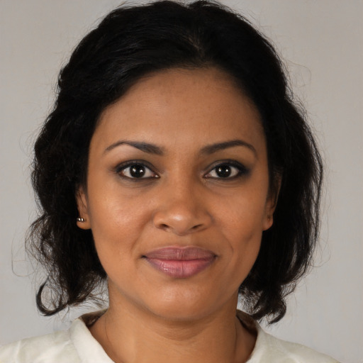 Joyful black young-adult female with medium  brown hair and brown eyes