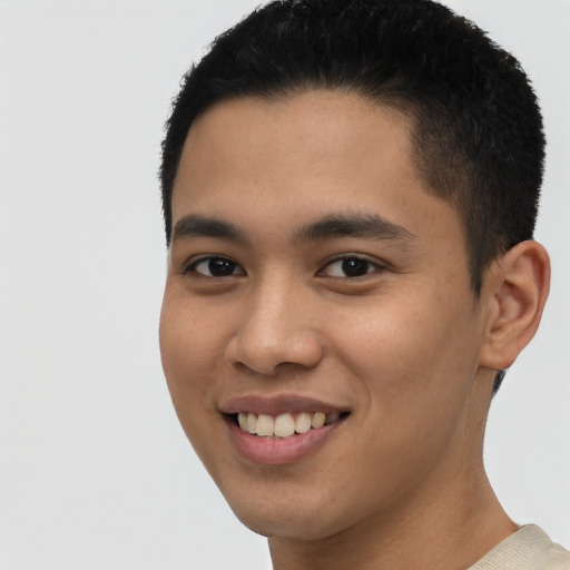 Joyful latino young-adult male with short  brown hair and brown eyes