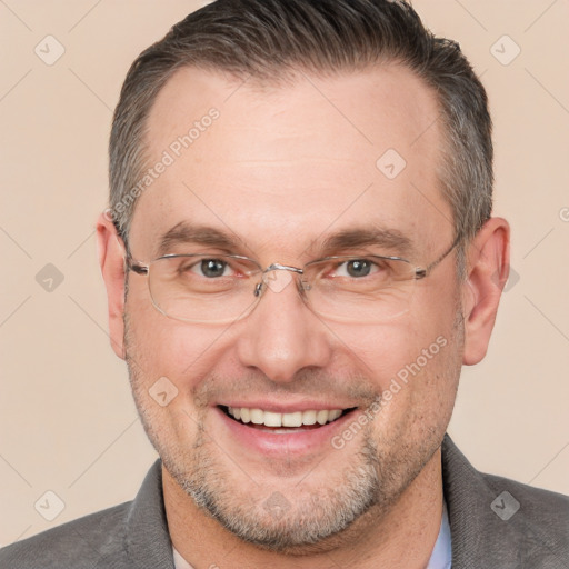 Joyful white adult male with short  brown hair and brown eyes