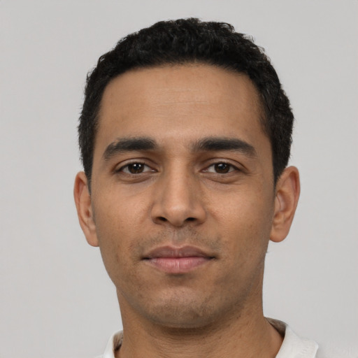 Neutral latino young-adult male with short  black hair and brown eyes
