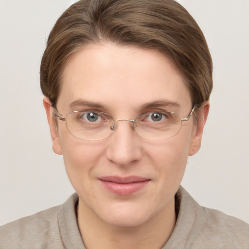 Joyful white adult female with short  brown hair and grey eyes