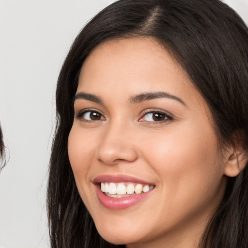 Joyful white young-adult female with long  brown hair and brown eyes