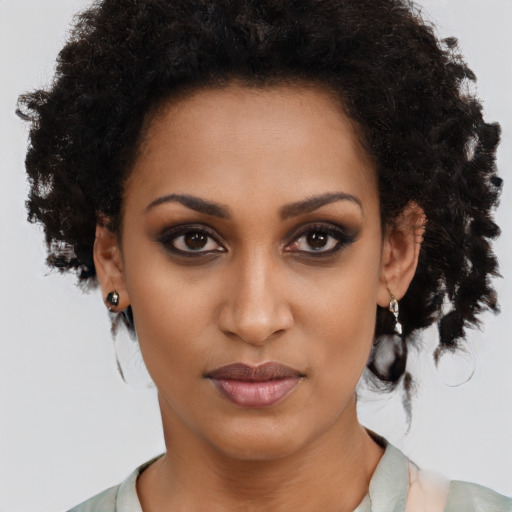 Joyful black young-adult female with medium  brown hair and brown eyes