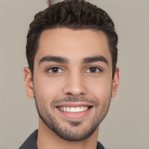 Joyful white young-adult male with short  black hair and brown eyes