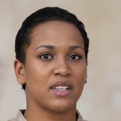 Joyful black young-adult female with short  brown hair and brown eyes