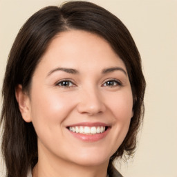 Joyful white young-adult female with medium  brown hair and brown eyes