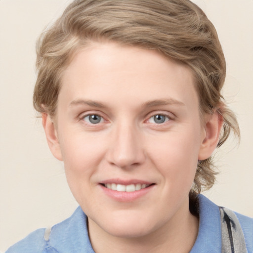 Joyful white young-adult female with medium  brown hair and blue eyes