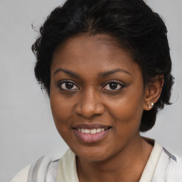 Joyful black young-adult female with medium  brown hair and brown eyes