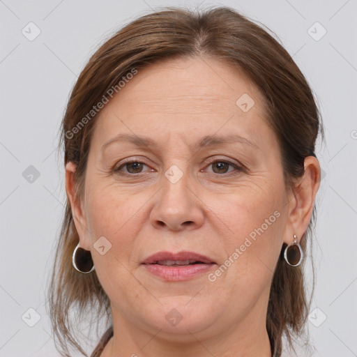 Joyful white adult female with medium  brown hair and grey eyes