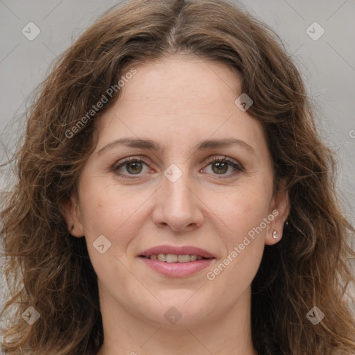 Joyful white adult female with long  brown hair and grey eyes