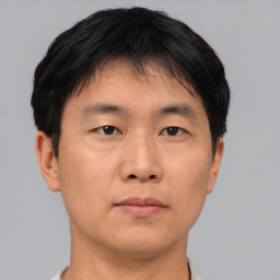 Neutral asian young-adult male with short  brown hair and brown eyes