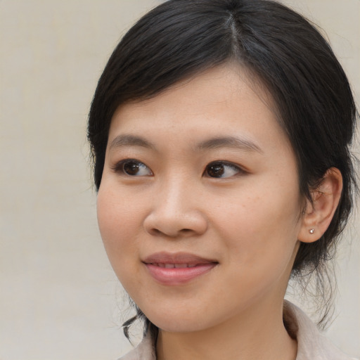 Joyful asian young-adult female with medium  brown hair and brown eyes