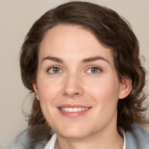 Joyful white young-adult female with medium  brown hair and green eyes