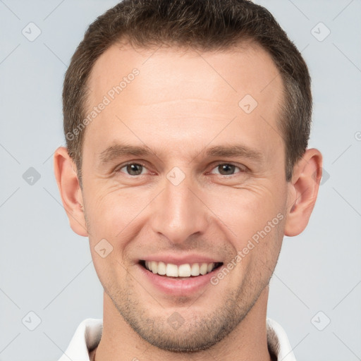 Joyful white young-adult male with short  brown hair and brown eyes