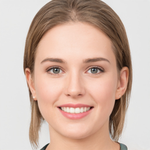 Joyful white young-adult female with medium  brown hair and blue eyes