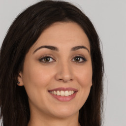 Joyful white young-adult female with long  brown hair and brown eyes