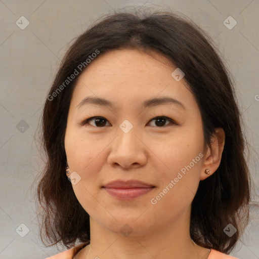 Joyful asian young-adult female with medium  brown hair and brown eyes