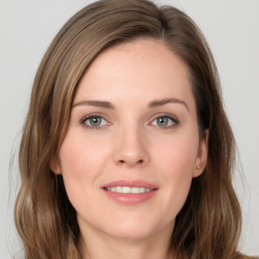 Joyful white young-adult female with long  brown hair and grey eyes