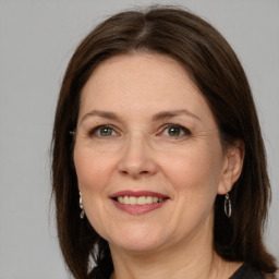 Joyful white adult female with medium  brown hair and grey eyes