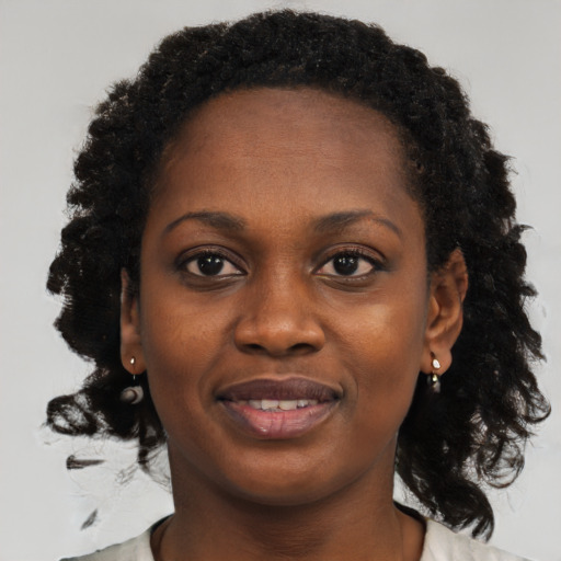 Joyful black young-adult female with medium  black hair and brown eyes