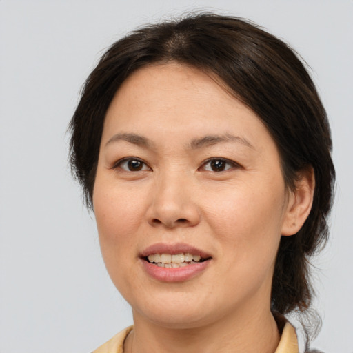 Joyful white adult female with medium  brown hair and brown eyes