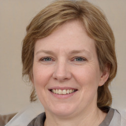 Joyful white adult female with medium  brown hair and grey eyes