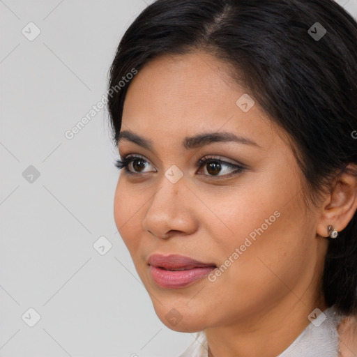 Joyful latino young-adult female with medium  brown hair and brown eyes