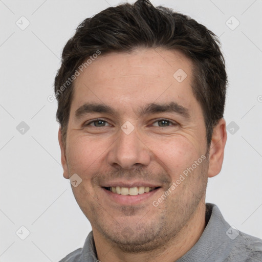 Joyful white adult male with short  brown hair and brown eyes