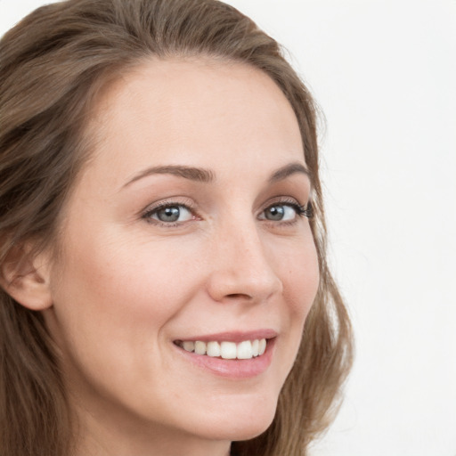 Joyful white young-adult female with long  brown hair and blue eyes