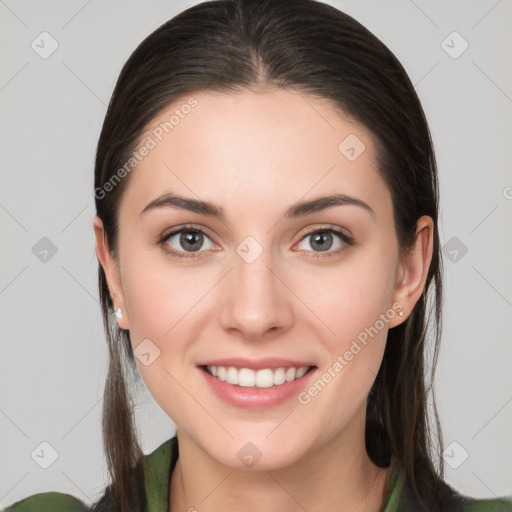 Joyful white young-adult female with long  brown hair and brown eyes