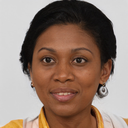 Joyful latino adult female with medium  brown hair and brown eyes