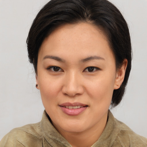 Joyful asian young-adult female with medium  brown hair and brown eyes