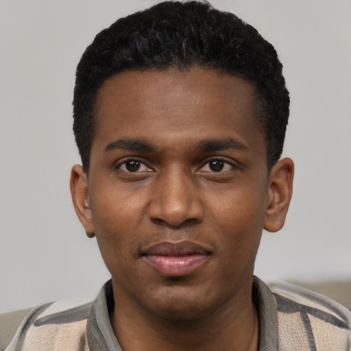Joyful latino young-adult male with short  black hair and brown eyes