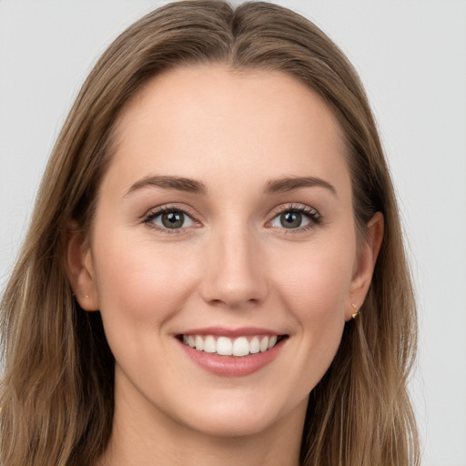 Joyful white young-adult female with long  brown hair and blue eyes