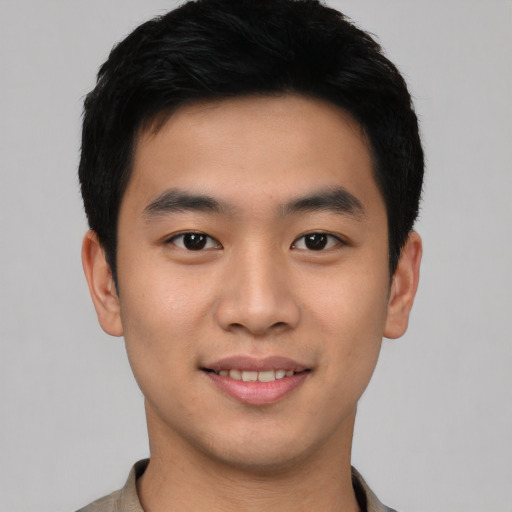 Joyful asian young-adult male with short  black hair and brown eyes