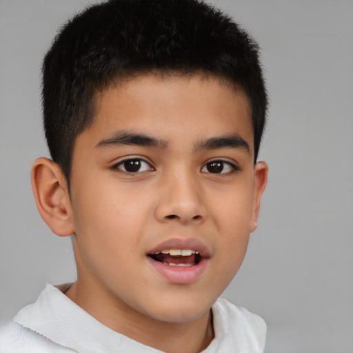 Joyful latino child male with short  brown hair and brown eyes