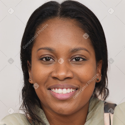 Joyful black young-adult female with long  brown hair and brown eyes