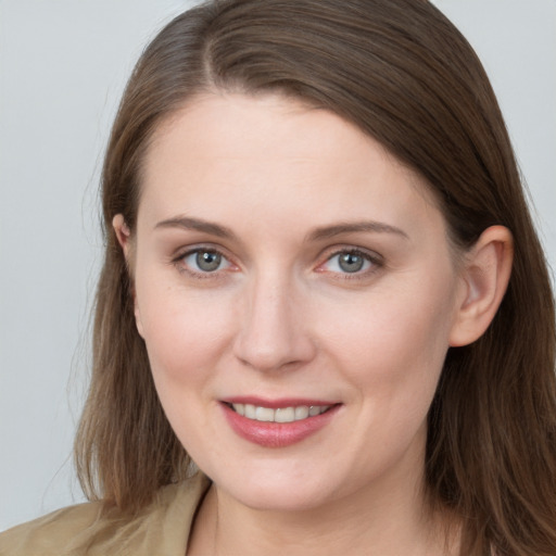 Joyful white young-adult female with long  brown hair and grey eyes