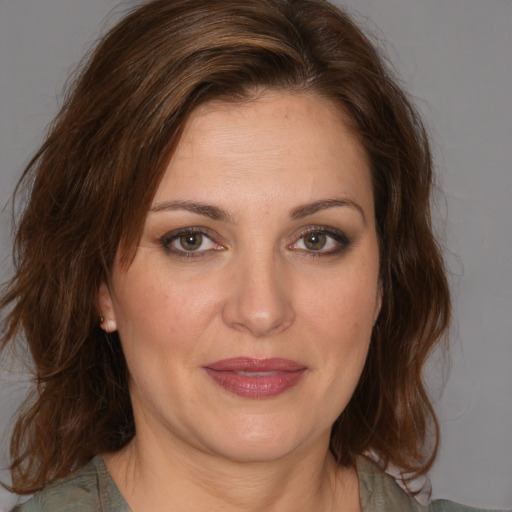 Joyful white adult female with medium  brown hair and brown eyes