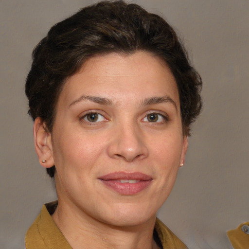 Joyful white adult female with short  brown hair and brown eyes