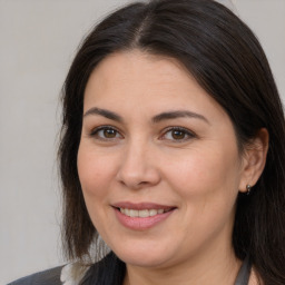 Joyful white adult female with long  brown hair and brown eyes