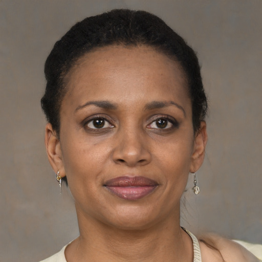 Joyful black adult female with short  brown hair and brown eyes