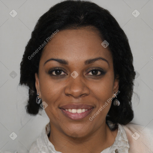 Joyful black adult female with medium  brown hair and brown eyes