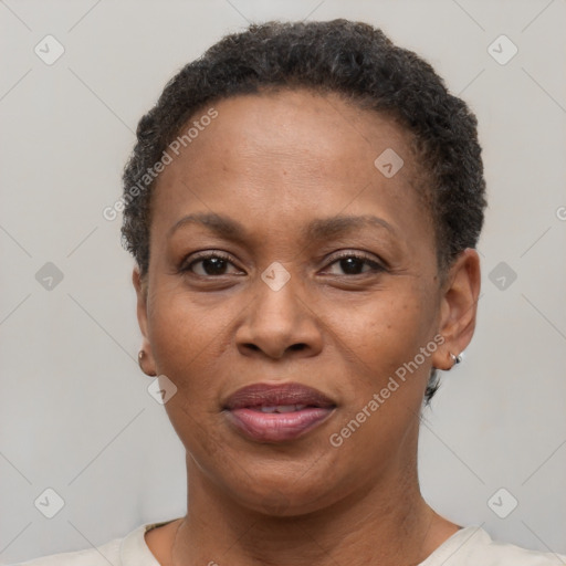 Joyful black adult female with short  brown hair and brown eyes