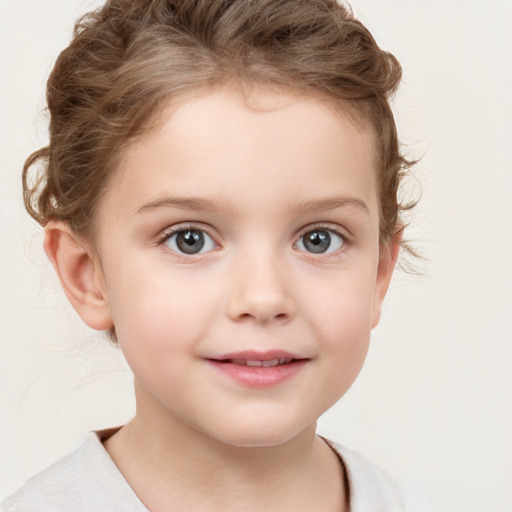 Joyful white child female with short  brown hair and brown eyes