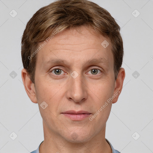 Joyful white adult male with short  brown hair and grey eyes