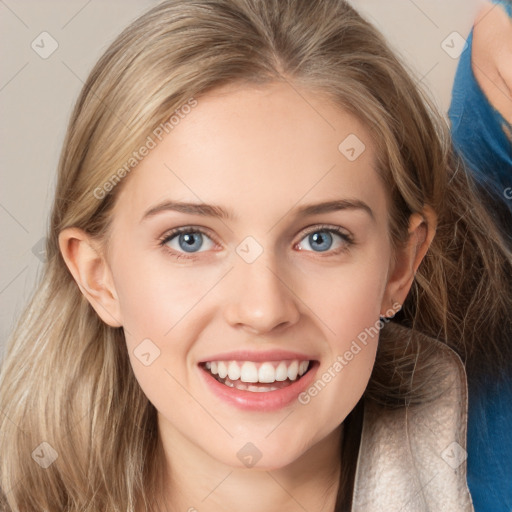 Joyful white young-adult female with long  brown hair and blue eyes