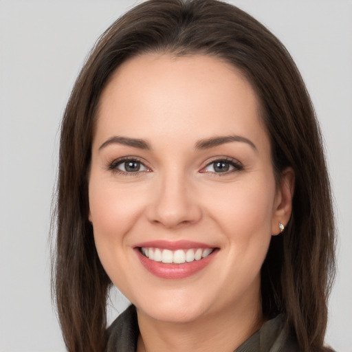 Joyful white young-adult female with long  brown hair and brown eyes