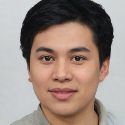 Joyful asian young-adult male with short  black hair and brown eyes