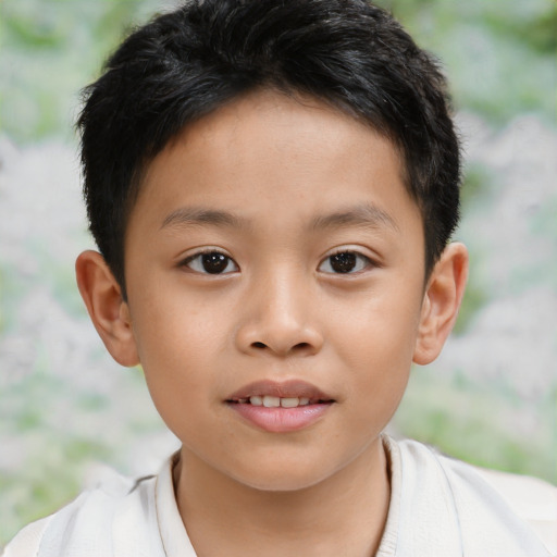Joyful asian child male with short  brown hair and brown eyes